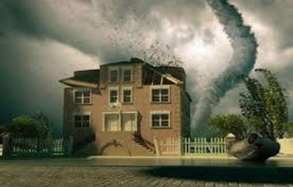 House with roof being damaged by a tornado